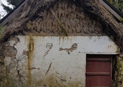 Old tin roofed thatched cottage